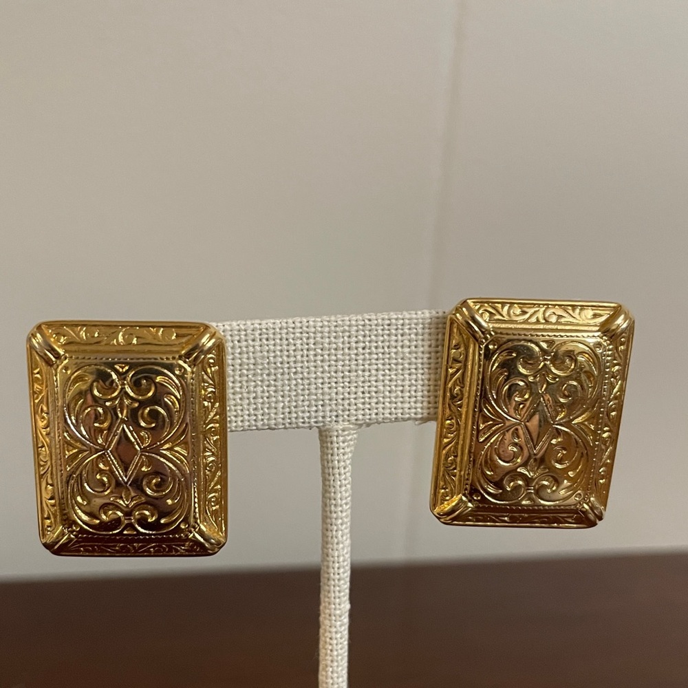 Gold tone earrings with intricate detailing. Vintage Ginnie Johansen GJD.